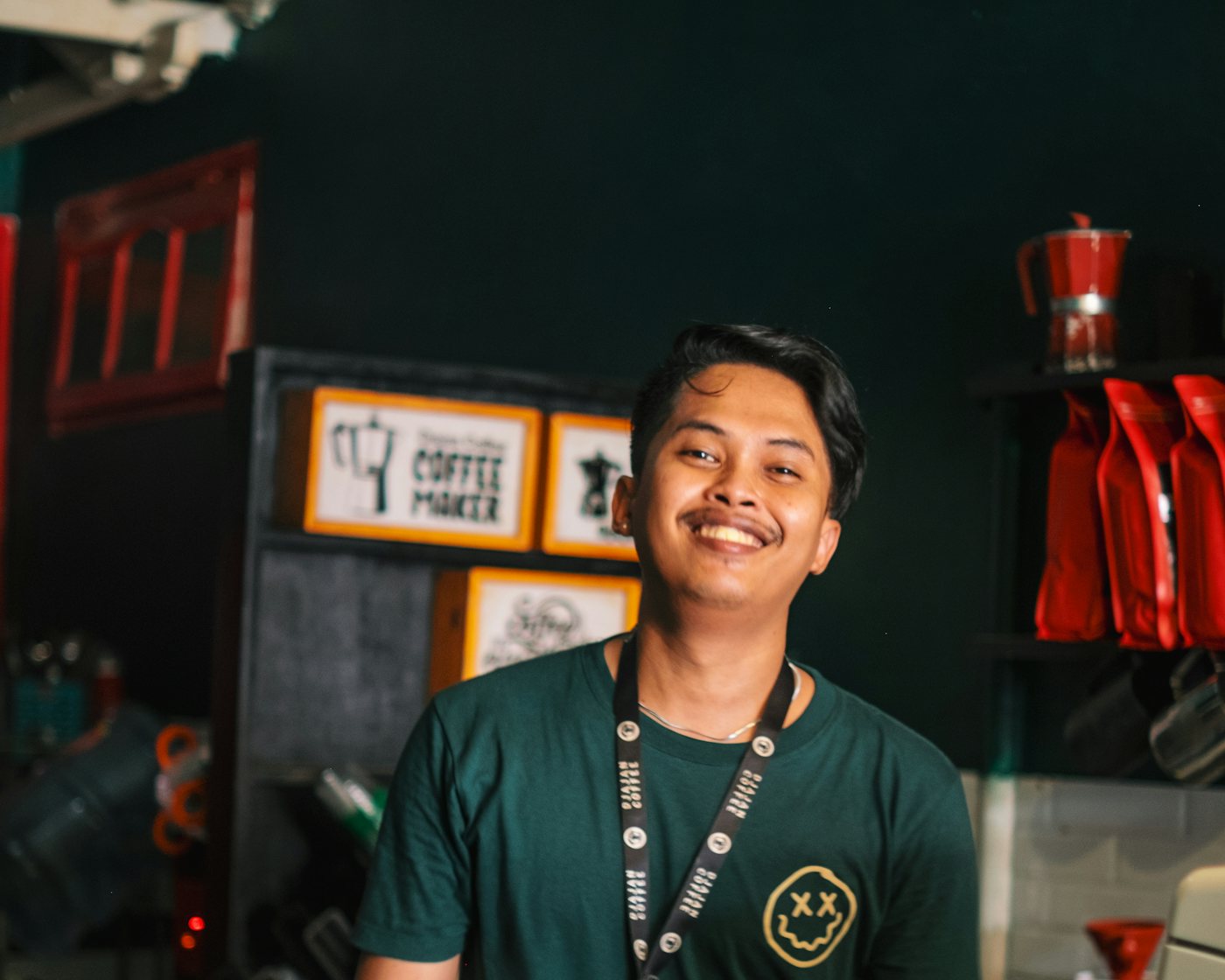Smiling small business owner behind his counter