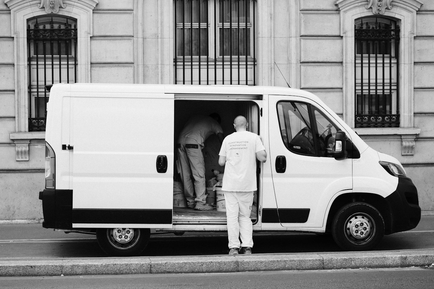 Service technician standing beside his work van
